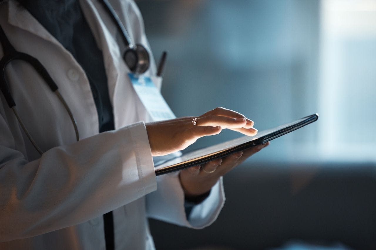 Doctor with a tablet | Image credit: stock.adobe.com - Rene L/peopleimages.com